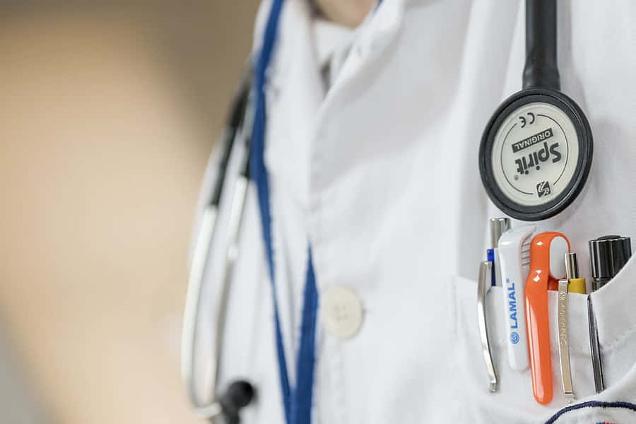 A Doctor's Coat With A Stethoscope And A Pen Wallpaper