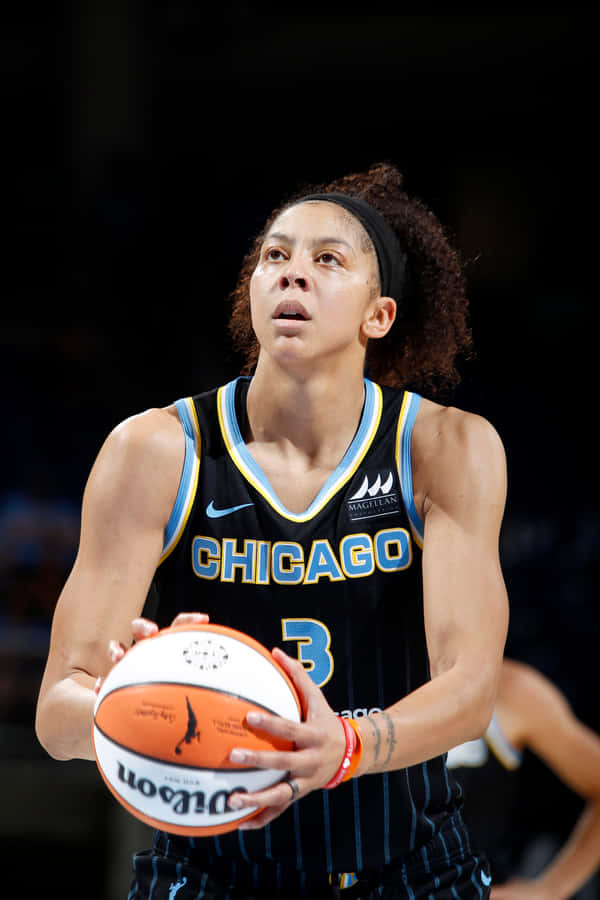 A Female Basketball Player Holding A Ball Wallpaper