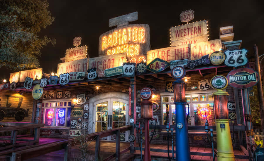 A Gas Station With Many Signs And Lights Wallpaper