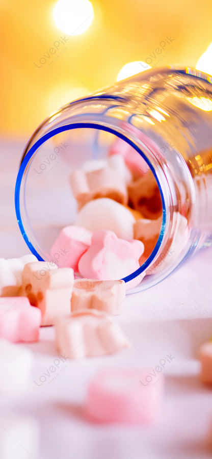 A Glass Bottle With Candy In It Wallpaper
