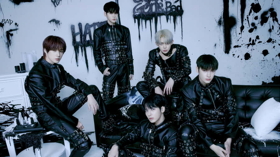 A Group Of Young Men In Black Leather Clothing Wallpaper