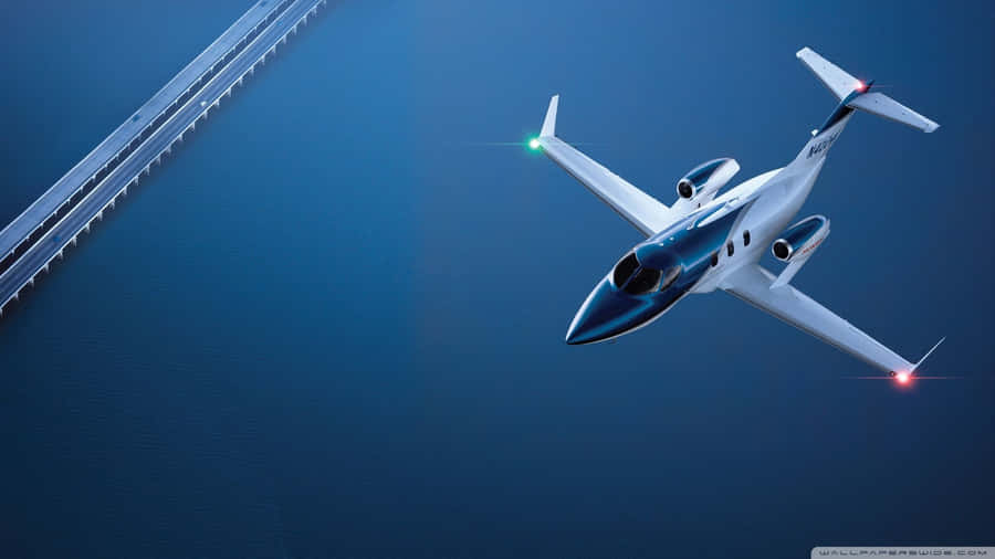 A Jet Airplane Flying Over A Bridge Wallpaper