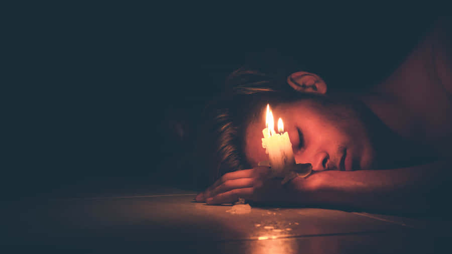 A Look Of Melancholic Reflection - Cool Sad Boy With Candle Wallpaper