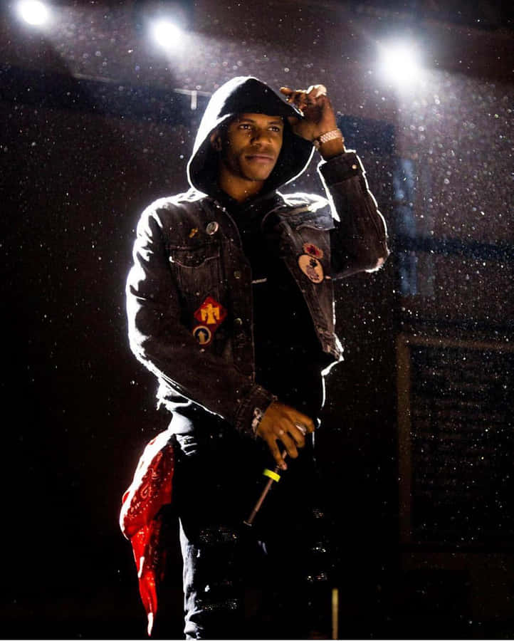 A Man In A Black Jacket Standing In The Rain Wallpaper