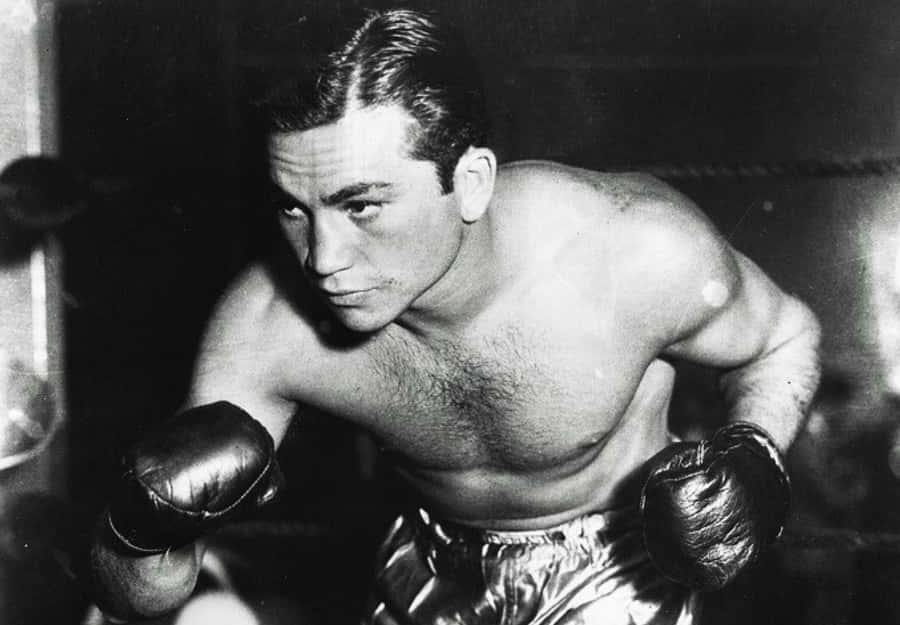 A Man In Boxing Gloves Is Posing For A Photo Wallpaper