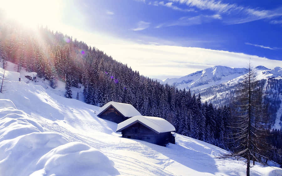 A Man Stands In Front Of Snow-covered Peaks And Mountains, Looking Out With Awe. Wallpaper