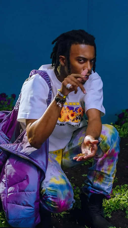 A Man With Dreadlocks And A Purple Backpack Wallpaper