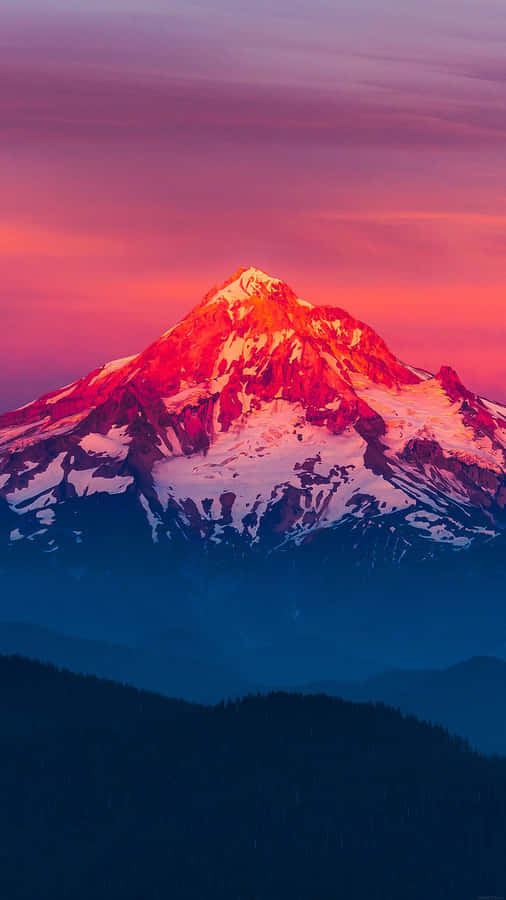 A Mountain Is Seen At Sunset With A Colorful Sky Wallpaper
