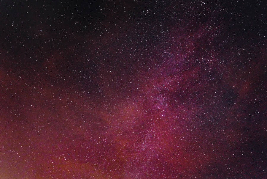 A Neon Pink Galaxy Filled With Stars Wallpaper