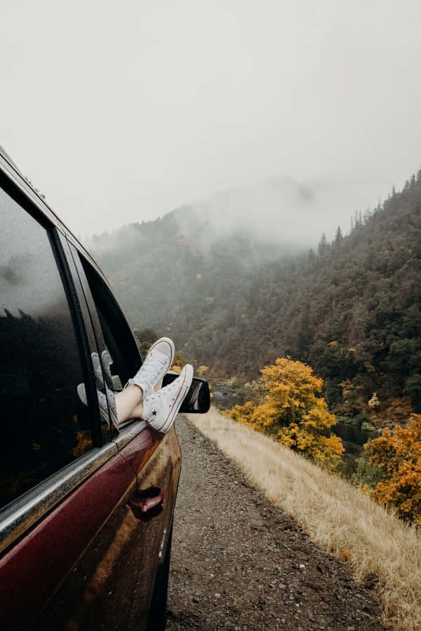 A Person Is Sitting In The Car Window Wallpaper