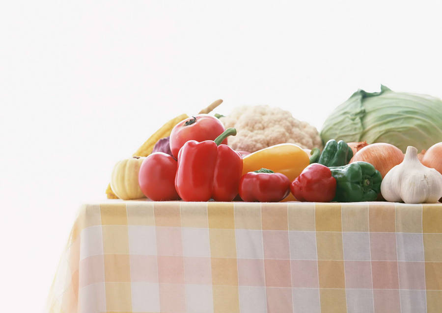 A Picnic Table Overflowing With Fresh Vegetables Wallpaper
