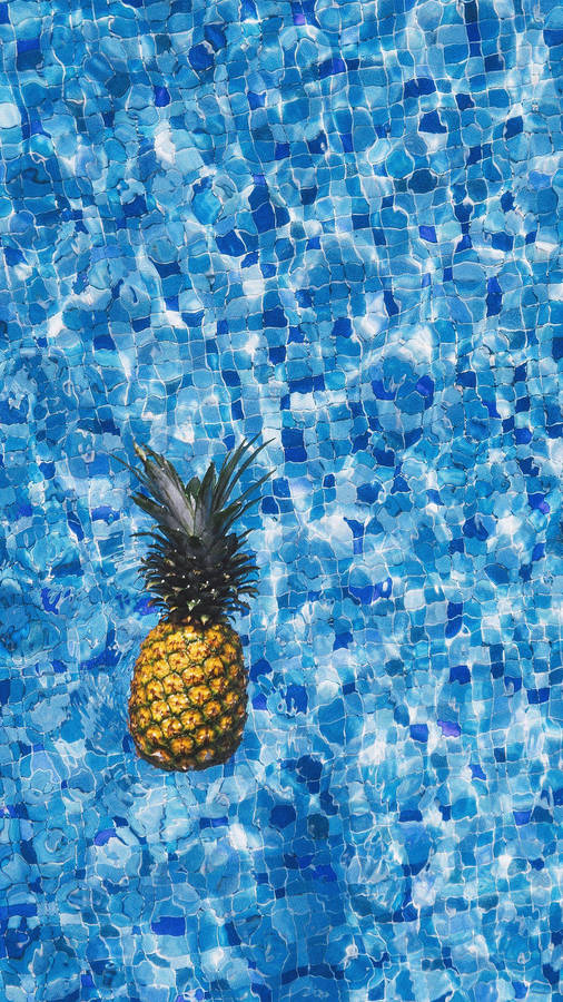 A Pineapple Floating In A Pool Wallpaper