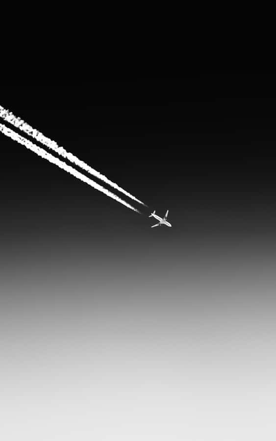 A Plane Flying In The Sky Wallpaper