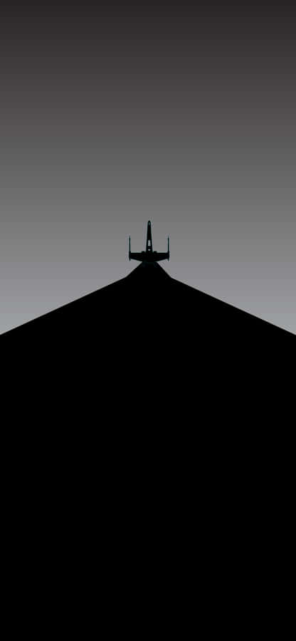 A Plane Is Silhouetted On A Runway Wallpaper