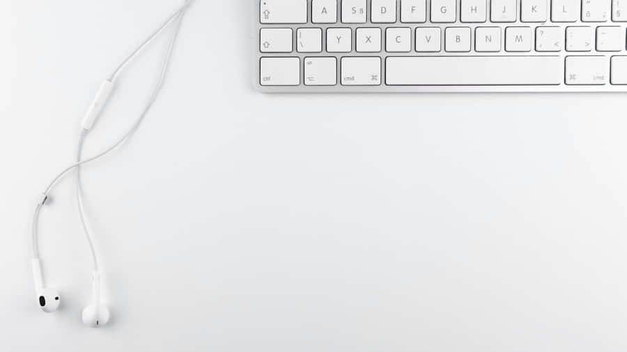 A Pristine White Laptop Provides The Perfect Aesthetic To Spark Creative Inspiration. Wallpaper