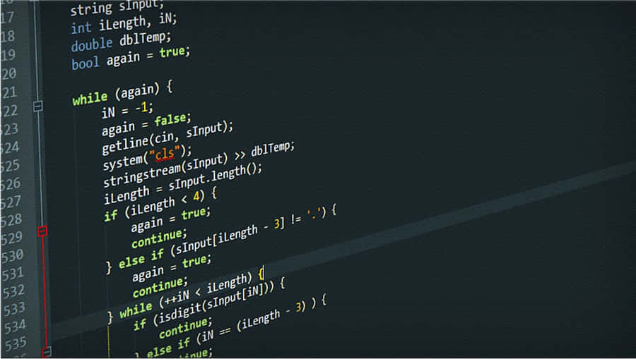 A Programmer Coding On A Computer Desktop. Wallpaper