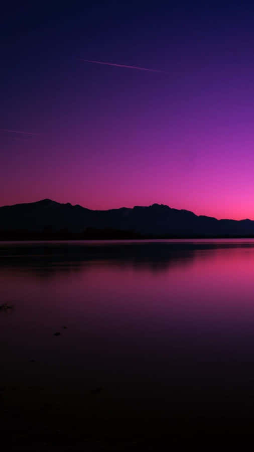 A Purple Sky With Mountains Wallpaper