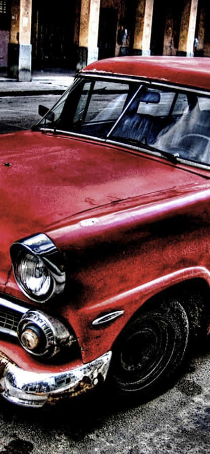 A Red Car Is Parked In Front Of A Building Wallpaper