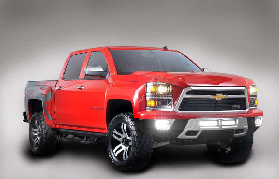 A Red Chevrolet Silverado Truck Is Shown In A Gray Background Wallpaper