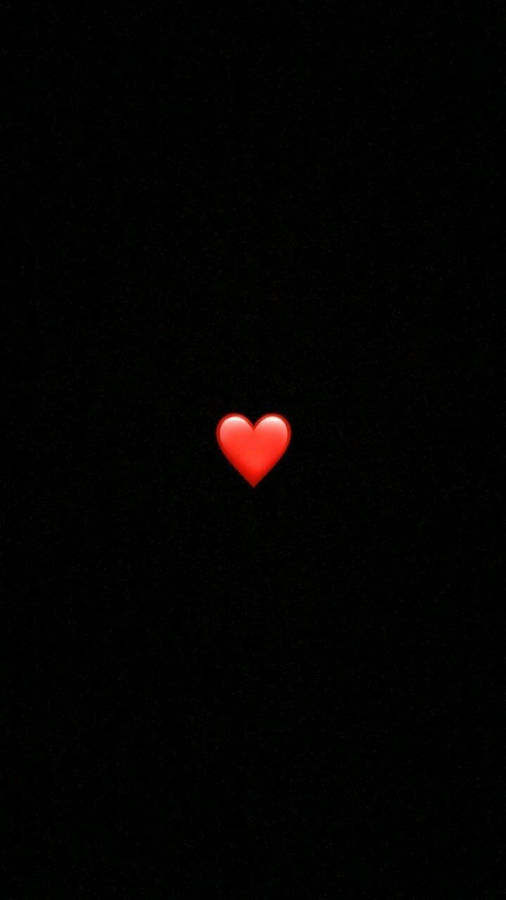 A Red Heart Is Lit Up In The Dark Wallpaper