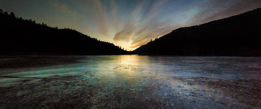 A Stunning Sunset Over A Nature Park Wallpaper