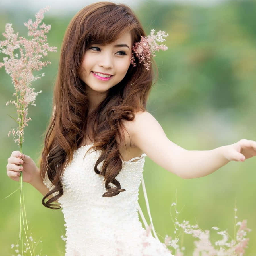 A Stylish Young Woman Using An Ipad In A Modern Cityscape Wallpaper