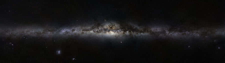 A View Of The Night Sky From The Edge Of A Cliff Wallpaper