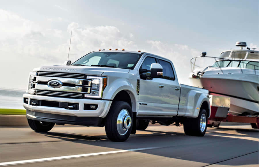 A White Ford Super Duty Truck Is Towing A Boat Wallpaper