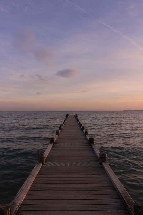 A Wooden Pier In The Water Wallpaper