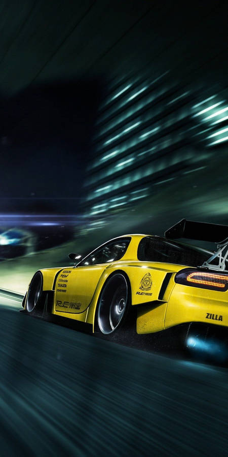 A Yellow Sports Car Driving Down A Dark Street Wallpaper
