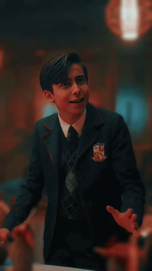 A Young Man In A Suit Standing In A Room Wallpaper