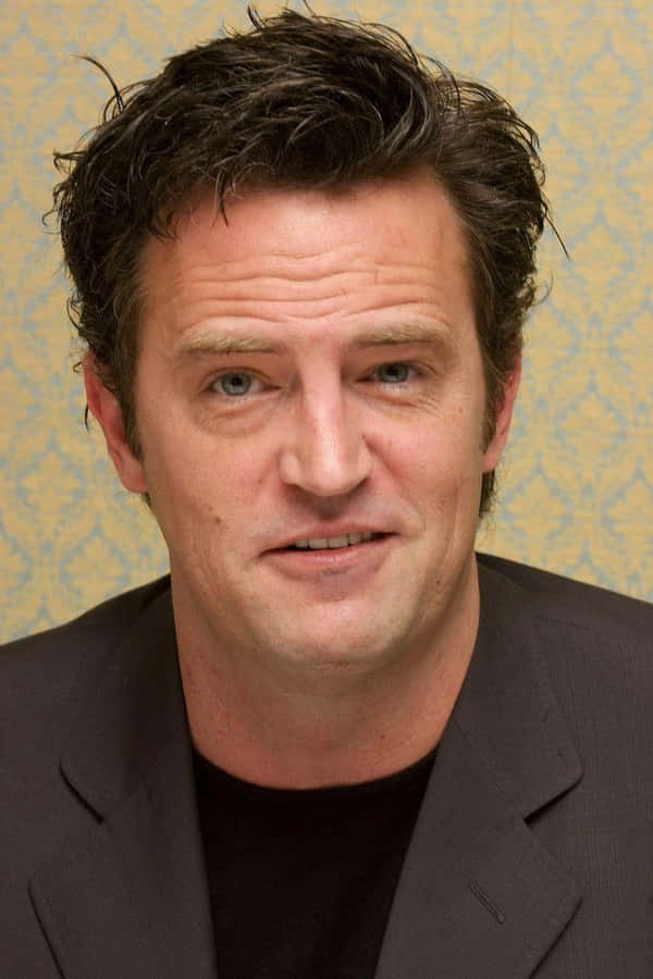 Actor Matthew Perry Smiles Into The Camera Wallpaper