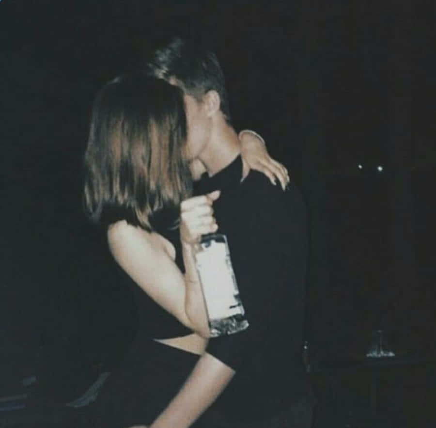 Adorable Couple Sharing A Romantic Moment Together Wallpaper