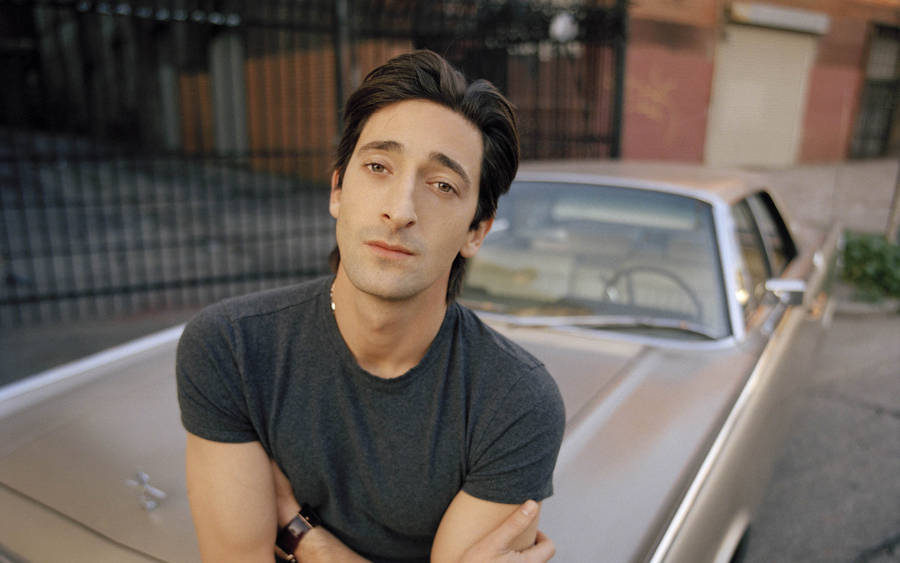 Adrien Brody On A Vintage Car Wallpaper