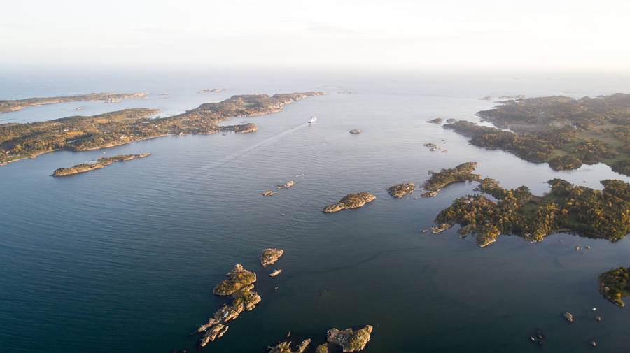 Aerial Photography Of Island During Daytime Wallpaper