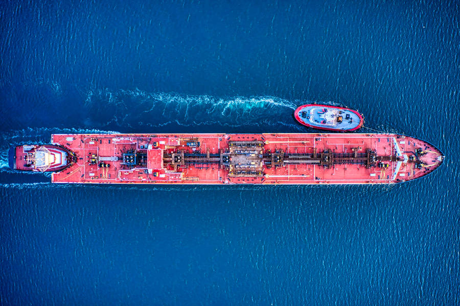 Aerial Shot Of A Red Cargo Ship At Sea Wallpaper