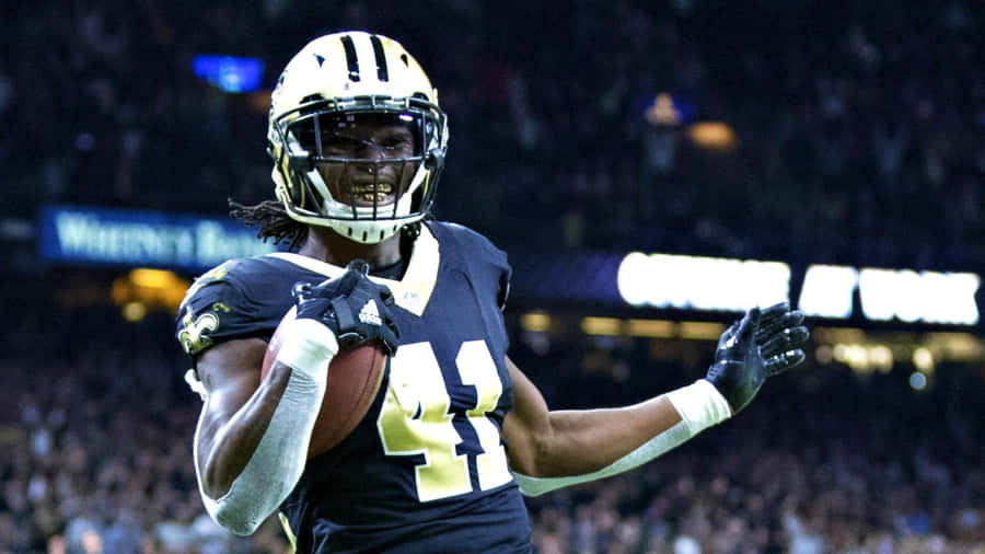 Alvin Kamara Of The New Orleans Saints Peers Downfield After Breaking Away From Defenders. Wallpaper