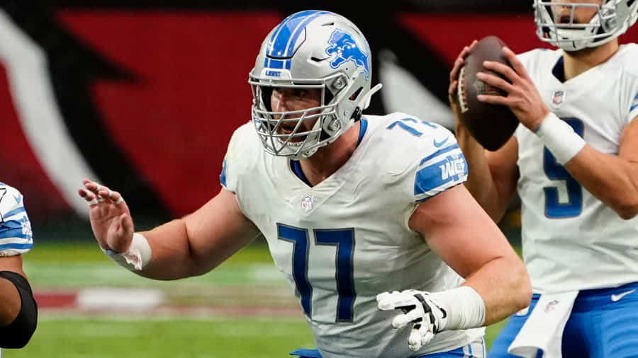 American Footballer Frank Ragnow With Teammates Wallpaper