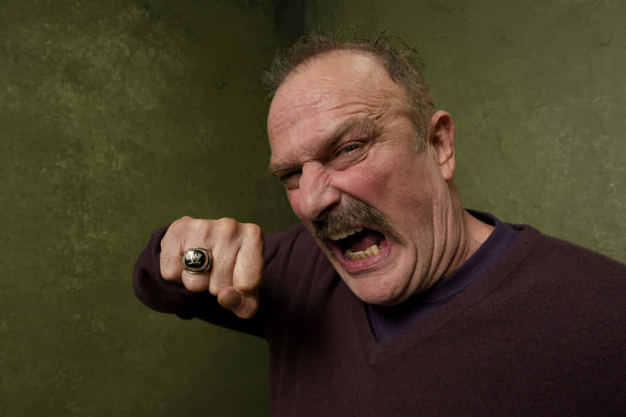 American Wrestler Jake Roberts Posing In The Village At The Lift Wallpaper