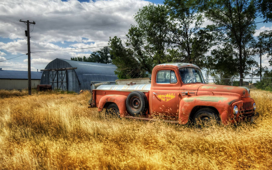 An Old Truck In A Field Wallpaper