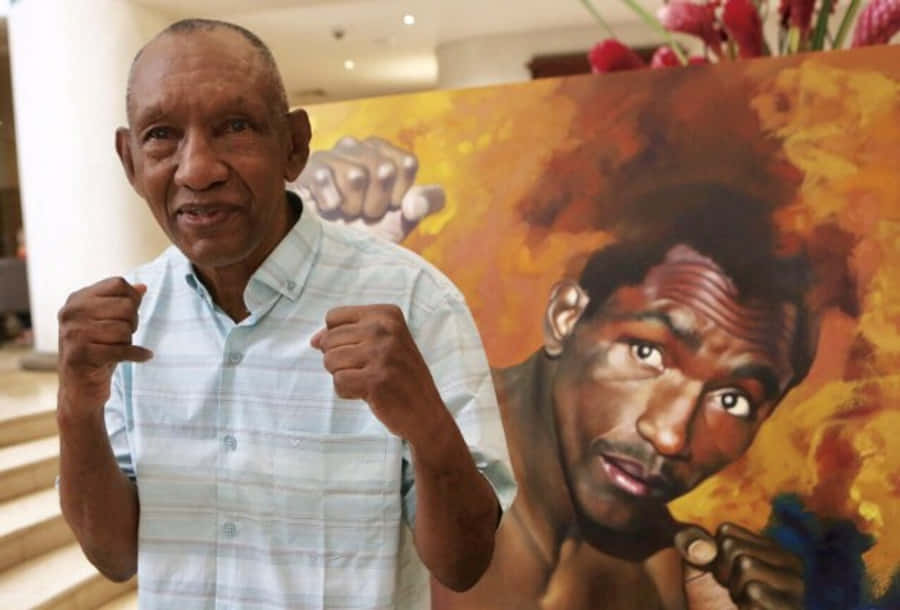 Antonio Cervantes And A Painting Of Younger Him Wallpaper