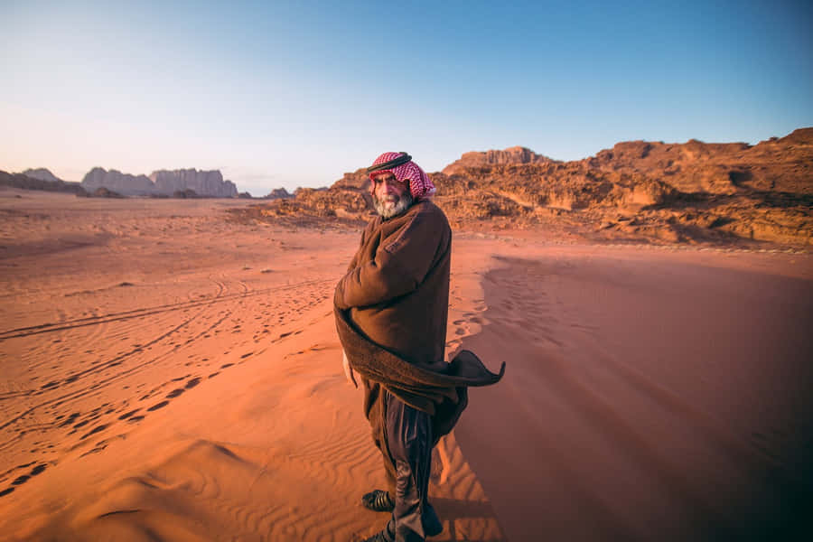 Arab Man Standing In Desert Wallpaper