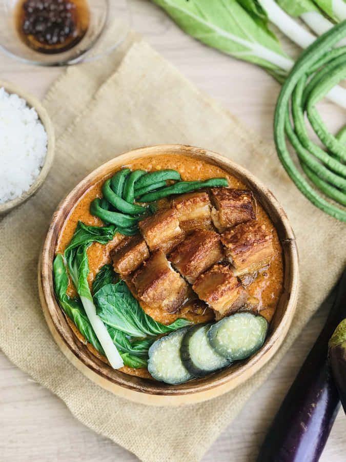 Authentic Filipino Kare-kare Served On A Traditional Platter Wallpaper