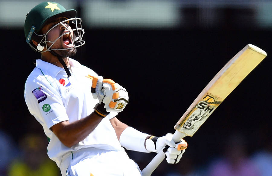 Babar Azam In His White Cricket Uniform Wallpaper