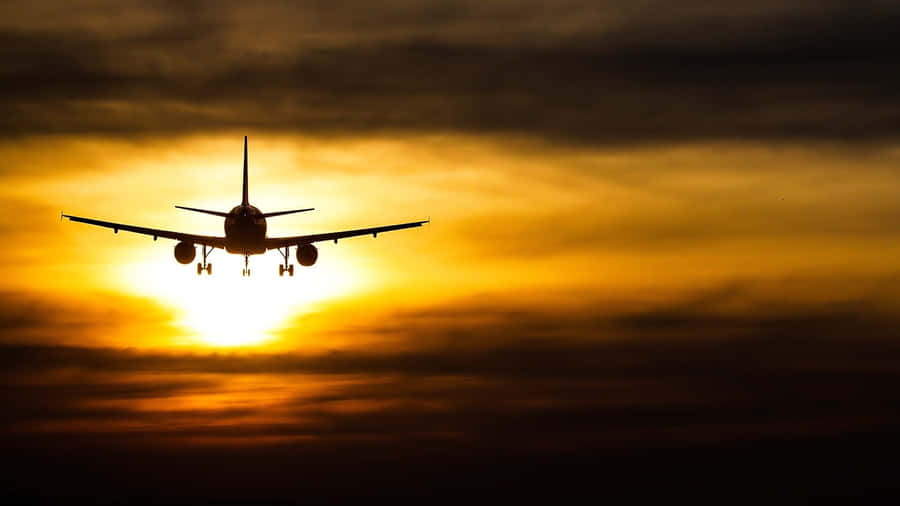 Beautiful Sunset Landing Plane Background Wallpaper
