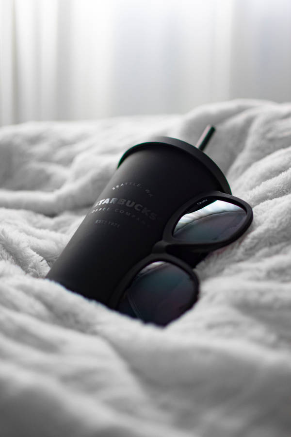 Black Camera Lens On White Textile Wallpaper