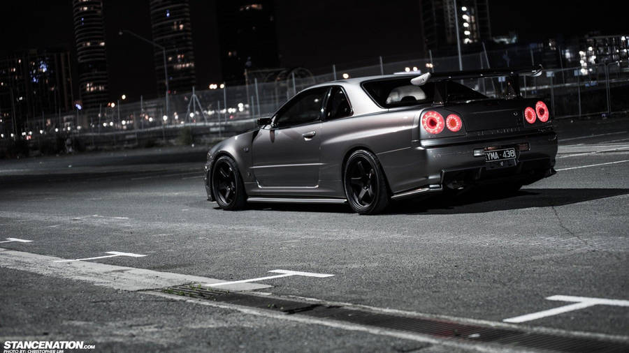 Blaze Through The City Streets With This Street Racing Inspired Jdm Nissan R34 Wallpaper
