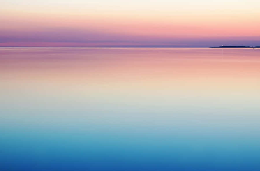 Blue And Purple Sunset With Calm Waters Wallpaper
