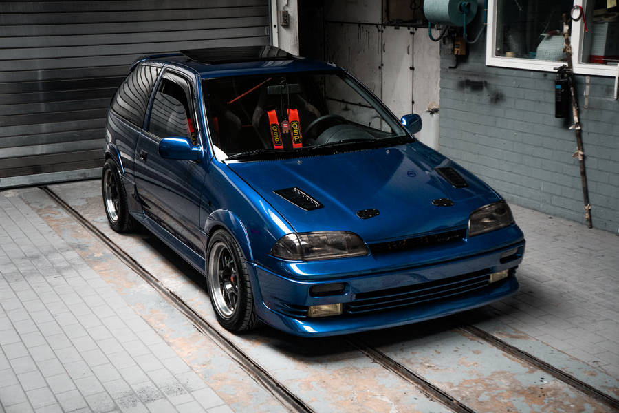 Blue Bmw M 3 Coupe Parked Beside White Building Wallpaper