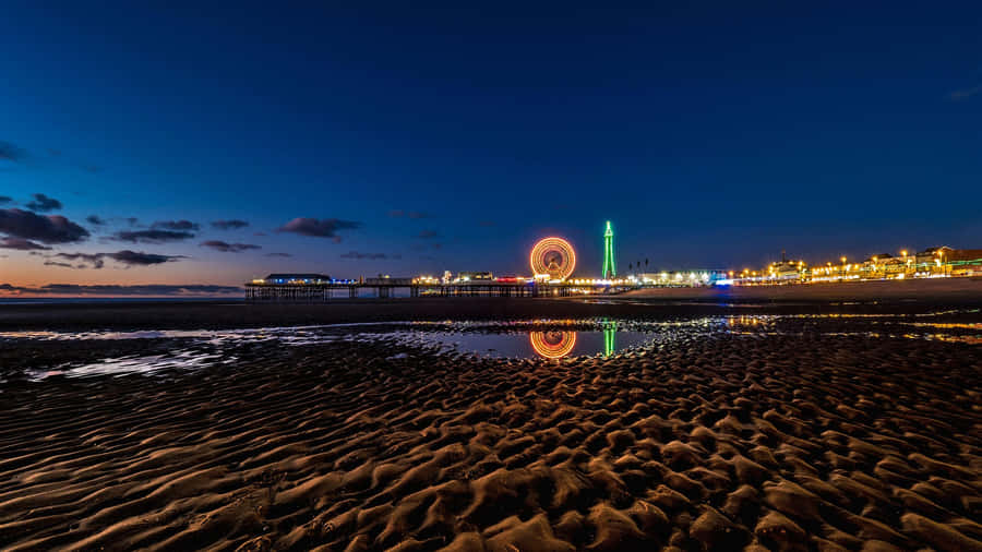 Breathtaking View Of Blackpool Tower Alongside Central Pier Big Wheel Wallpaper